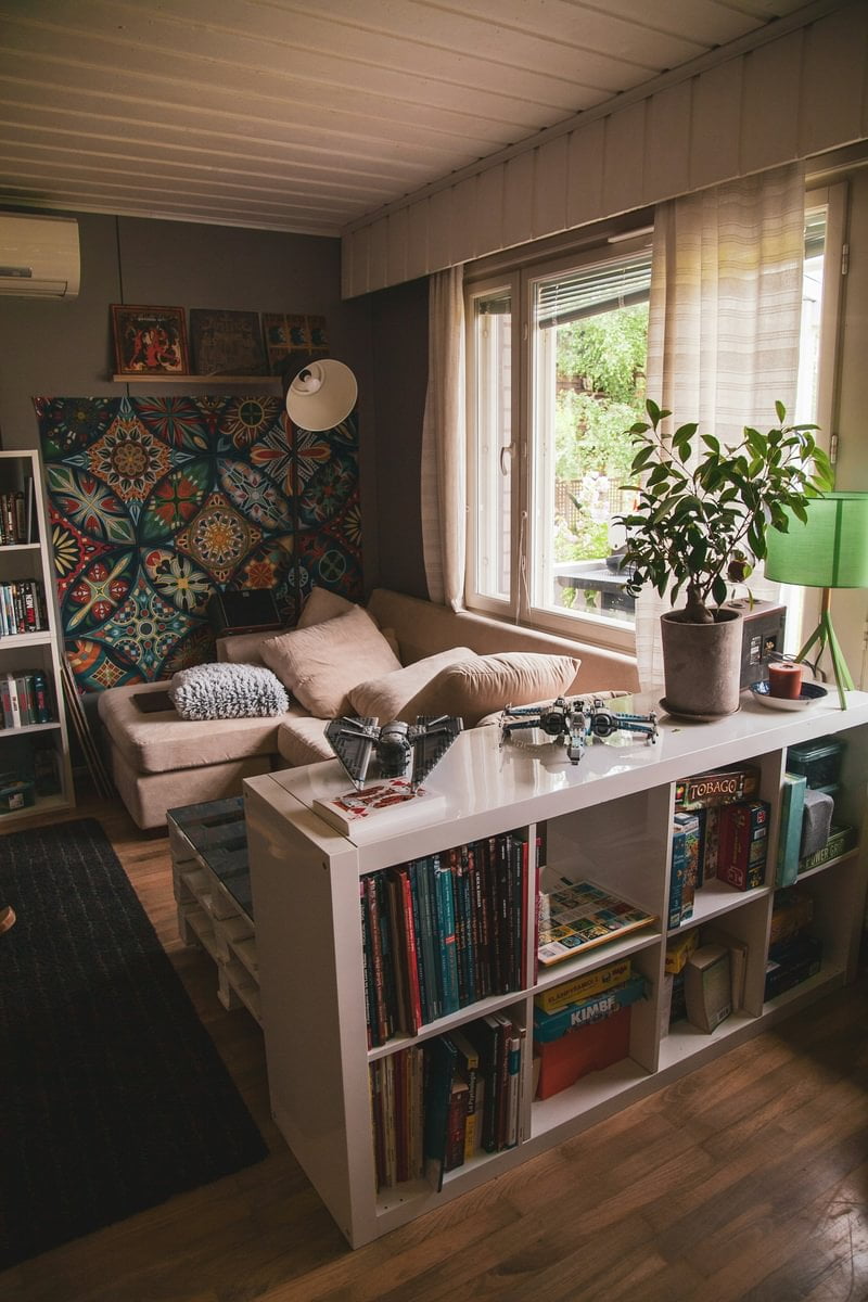 A white bookshelf in a living room, next to a sofa