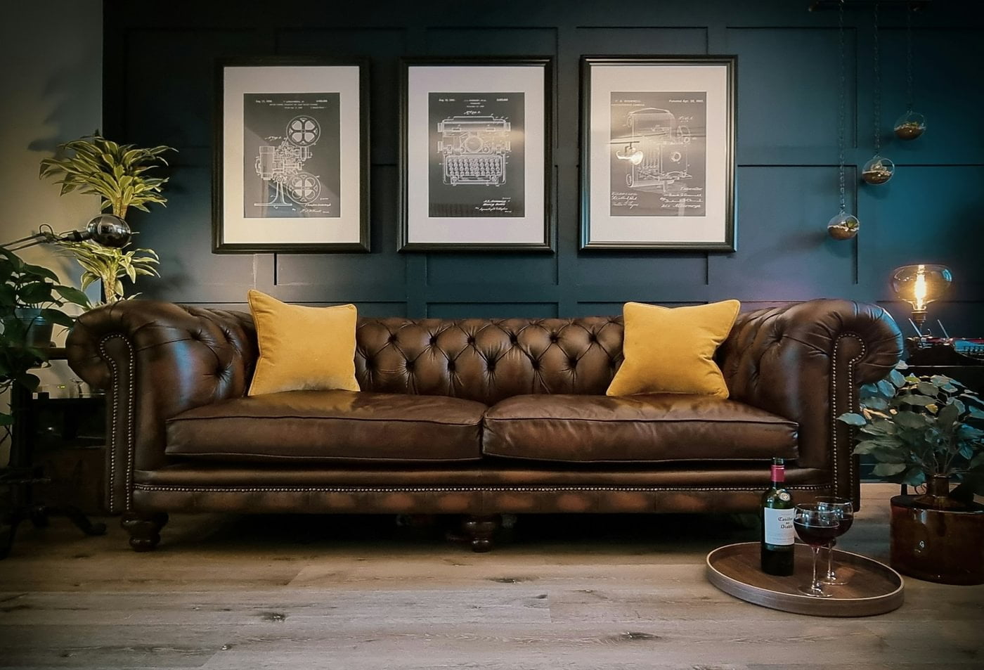 A brown chesterfield sofa with yellow cushions