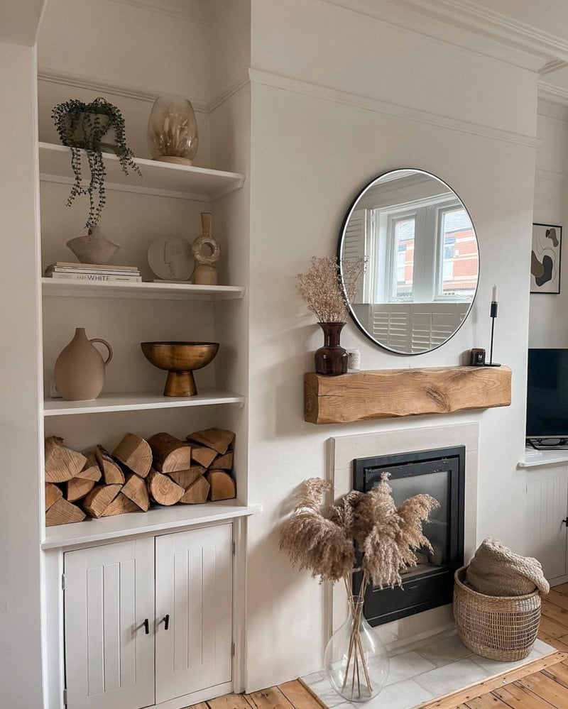 Neutral chimney breast with wooden mantlepiece, wall-mounted mirror and shelf decor